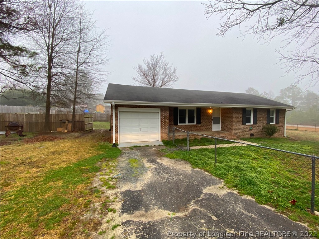 269 Azalea Drive Spring Lake, NC 28390 - Photo 1 of 13 a front view of a house with a yard and garage