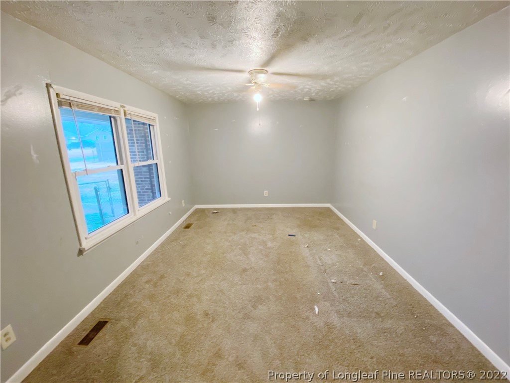 269 Azalea Drive Spring Lake, NC 28390 - Photo 3 of 13 an empty room with a workbench