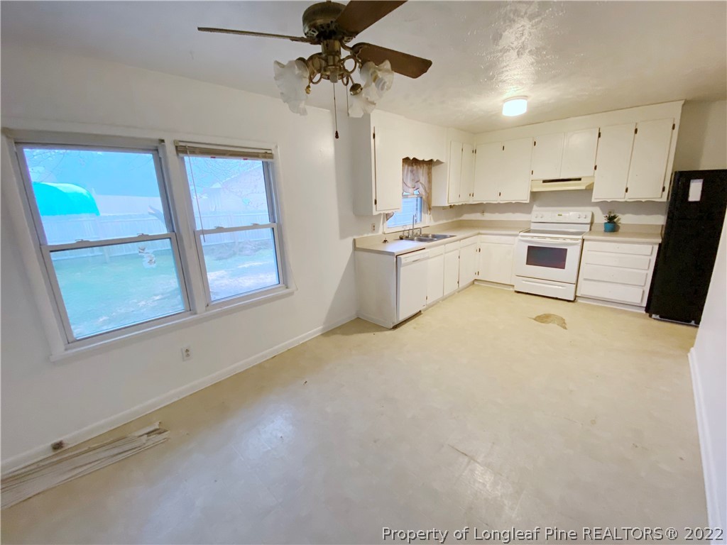 269 Azalea Drive Spring Lake, NC 28390 - Photo 6 of 13 a kitchen with white cabinets and appliances