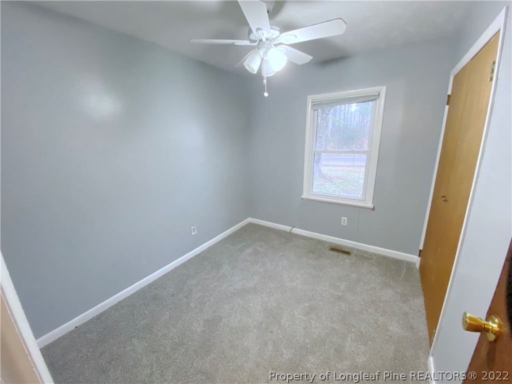 269 Azalea Drive Spring Lake, NC 28390 - Photo 8 of 13 an empty room with windows and fan