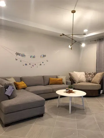 a living room with furniture and a lamp