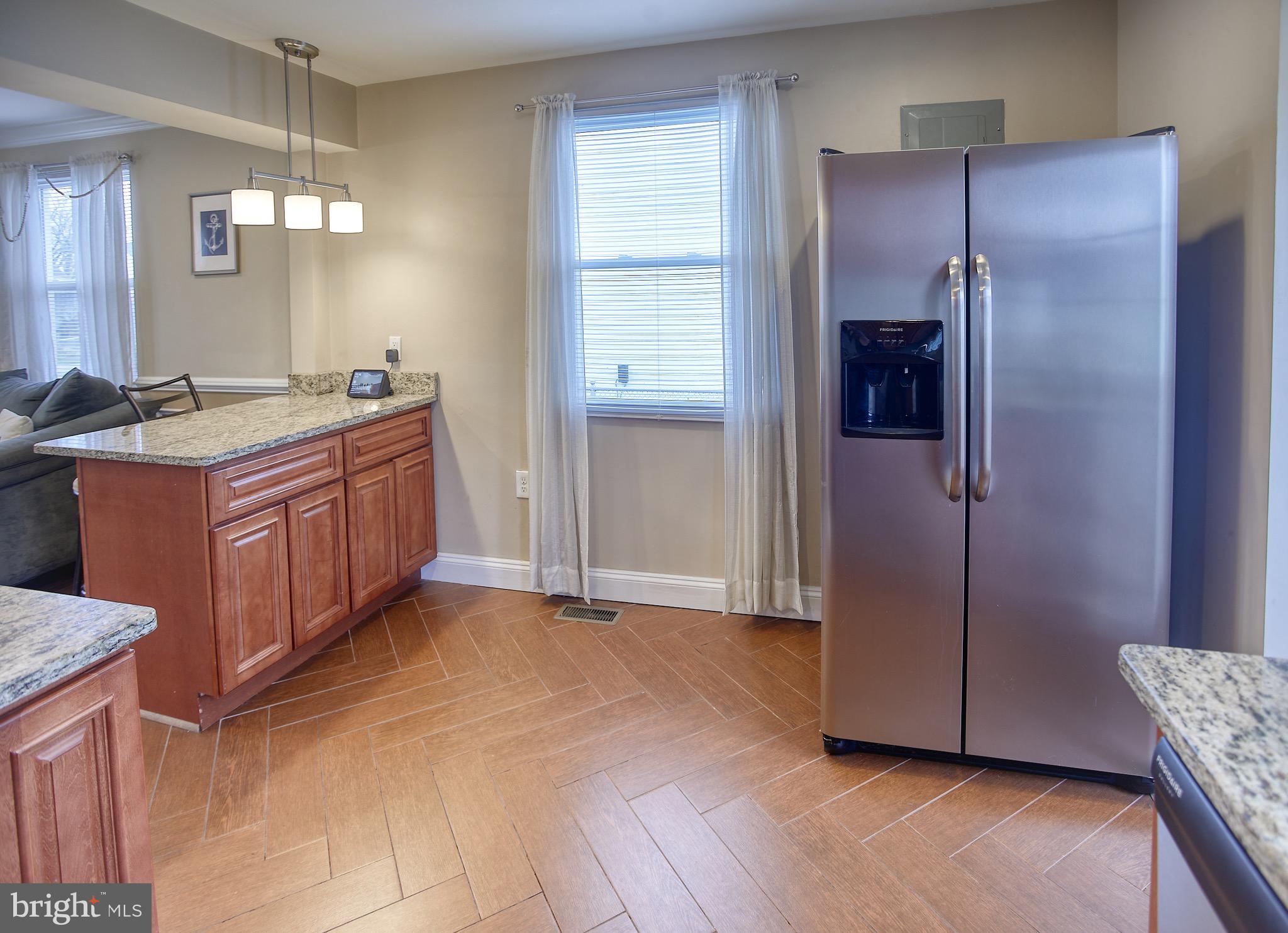 8220 Longpoint Road Dundalk, MD 21222 - Photo 11 of 22 a kitchen with stainless steel appliances granite countertop a refrigerator and a sink