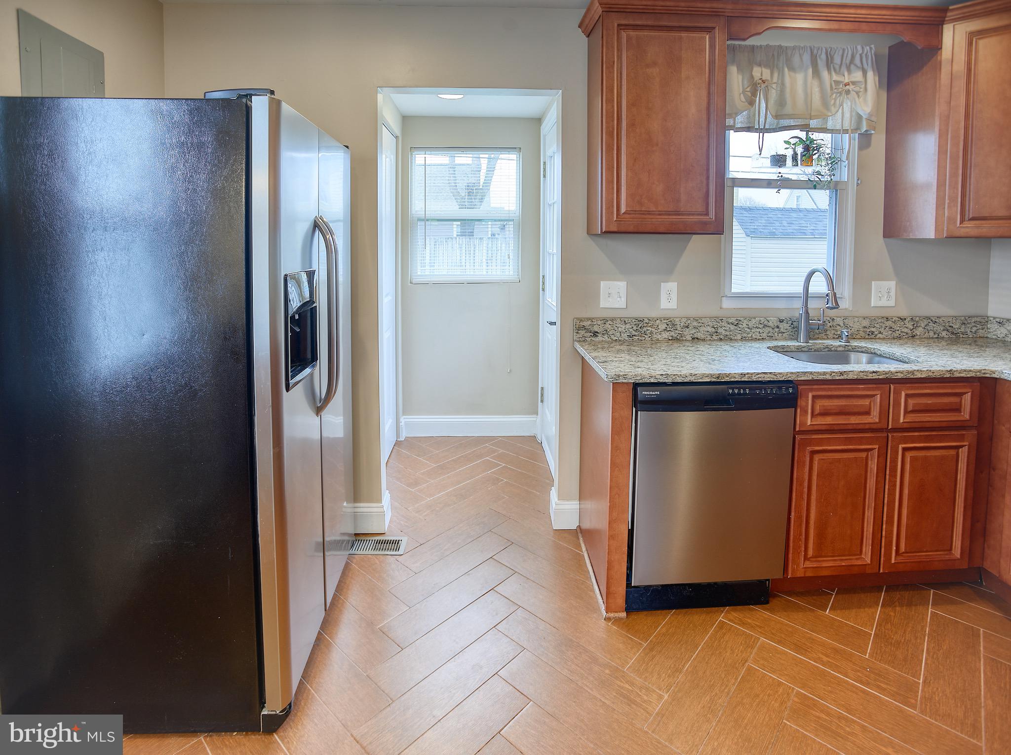 8220 Longpoint Road Dundalk, MD 21222 - Photo 12 of 22 a kitchen with stainless steel appliances granite countertop a refrigerator and a sink