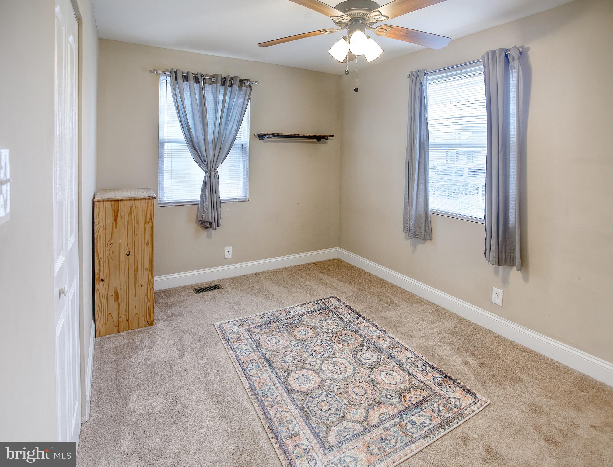 8220 Longpoint Road Dundalk, MD 21222 - Photo 14 of 22 wooden floor in an empty room with a window