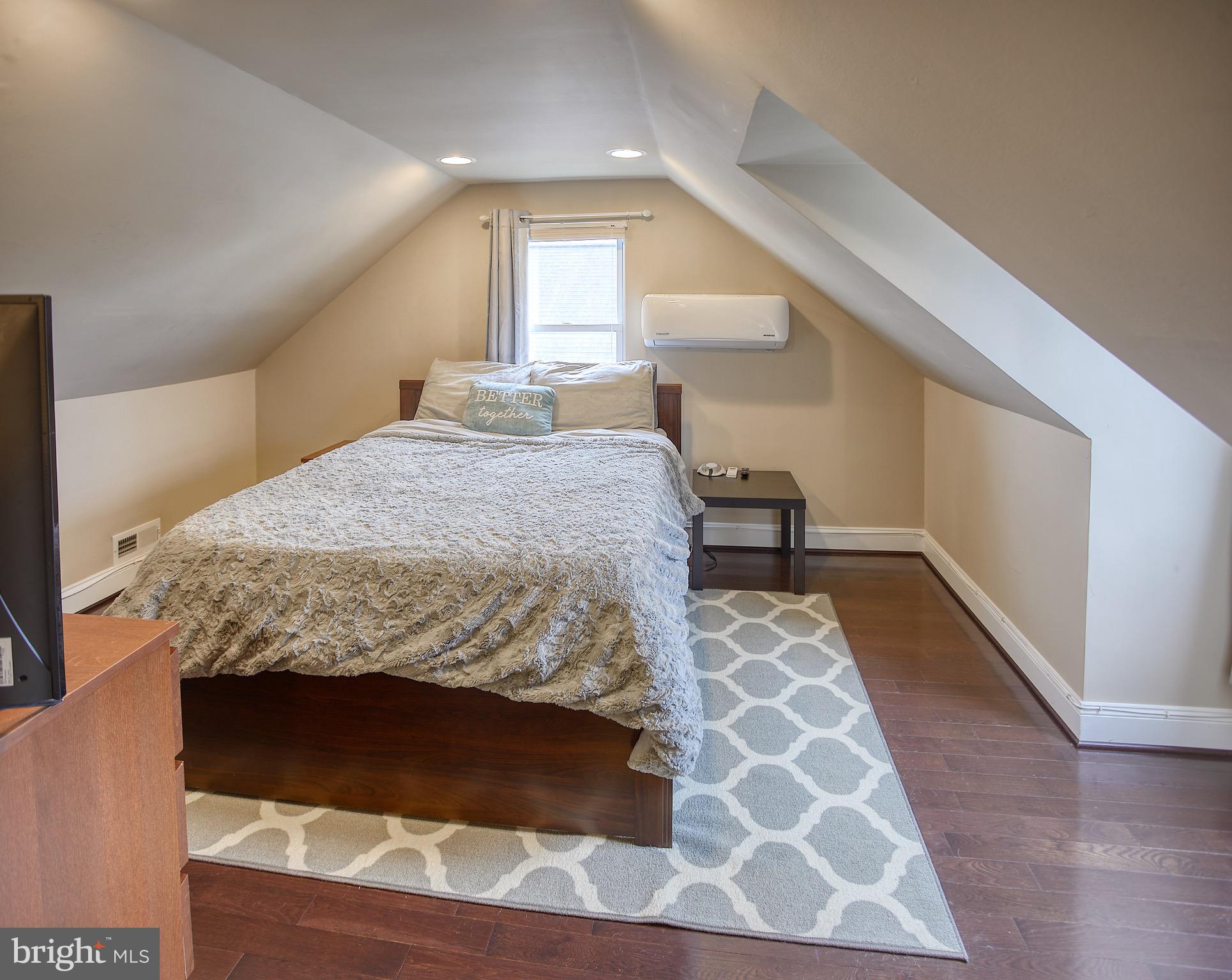 8220 Longpoint Road Dundalk, MD 21222 - Photo 19 of 22 a bedroom with a bed and wooden floor