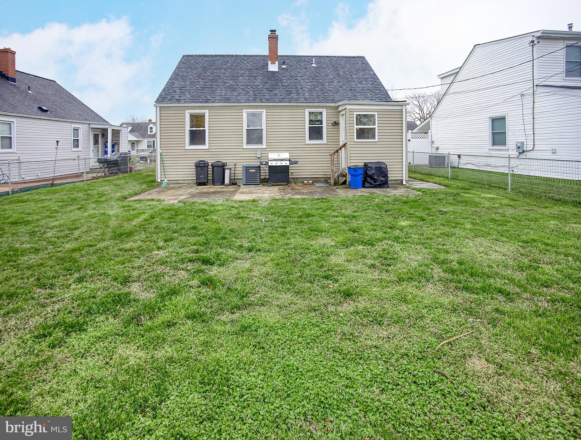8220 Longpoint Road Dundalk, MD 21222 - Photo 3 of 22 a front view of a house with a yard and trees