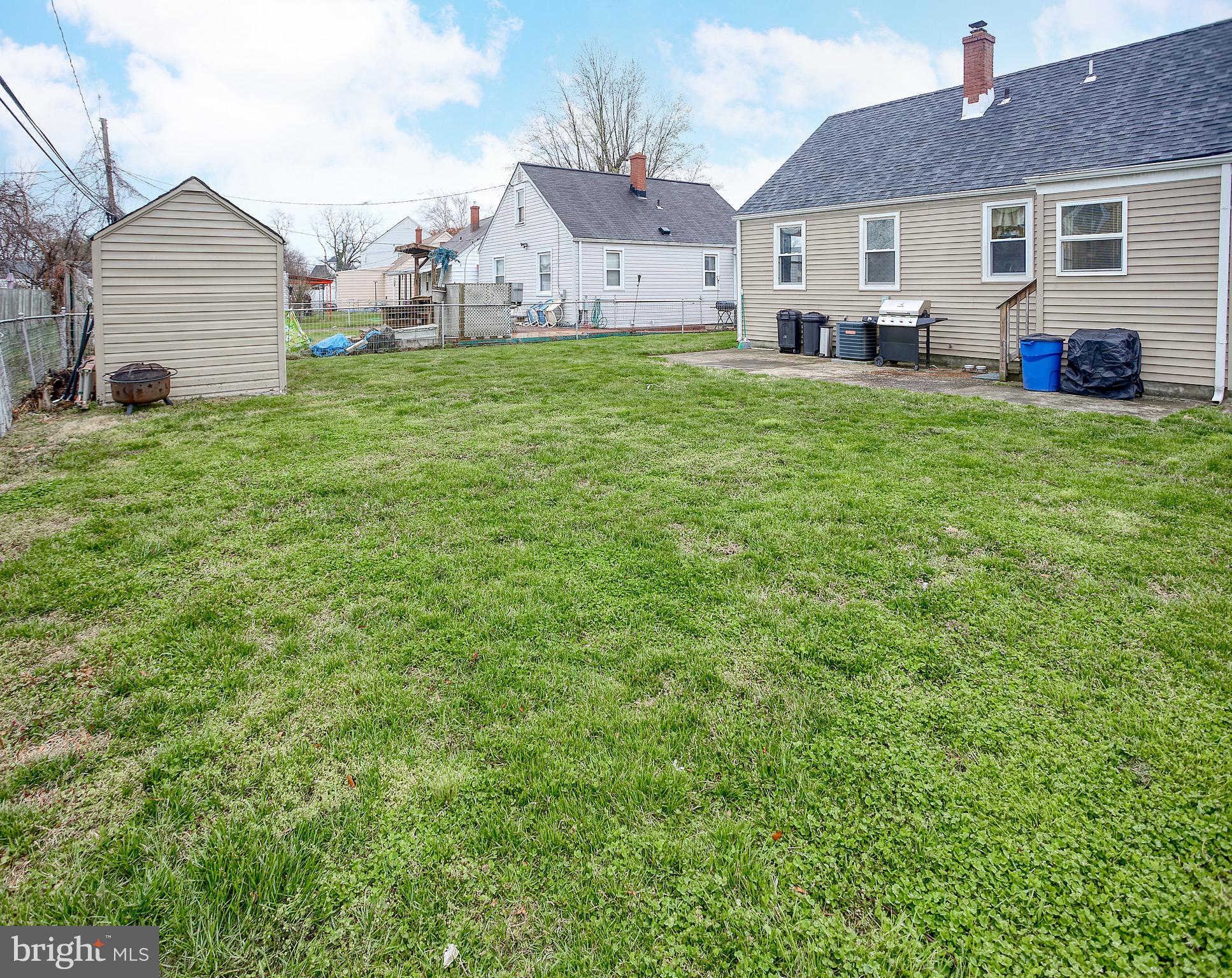 8220 Longpoint Road Dundalk, MD 21222 - Photo 5 of 22 a view of a house with a big yard and large trees