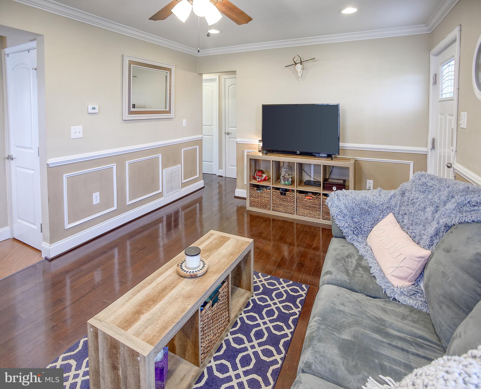 8220 Longpoint Road Dundalk, MD 21222 - Photo 7 of 22 a living room with furniture and a flat screen tv