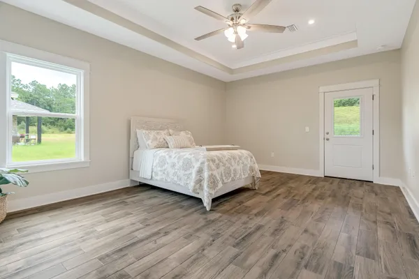 a very nice looking room with wooden floor and a bathroom
