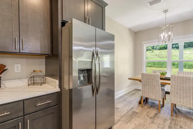 a kitchen with kitchen island a counter top space cabinets and stainless steel appliances