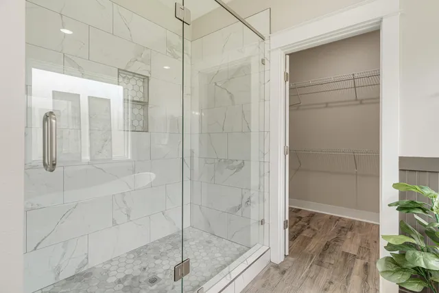 a very nice looking room with wooden floor and a bathroom