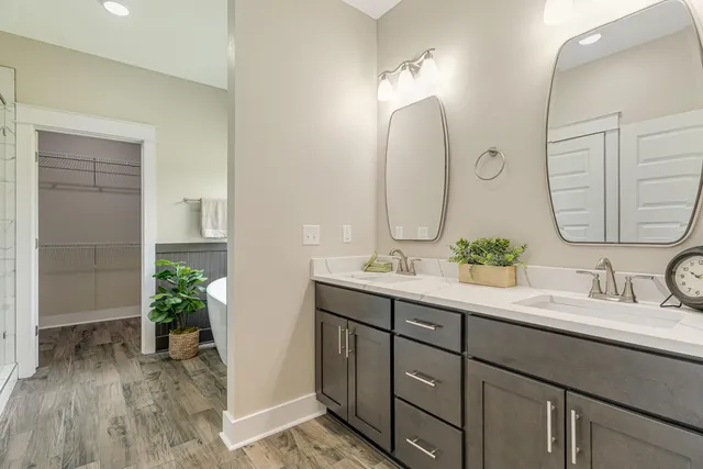 a bathroom with a double vanity sink and a mirror
