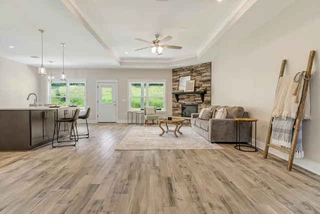 a living room with furniture and a wooden floor
