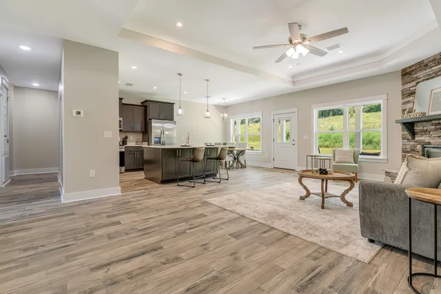 a living room with furniture and a wooden floor