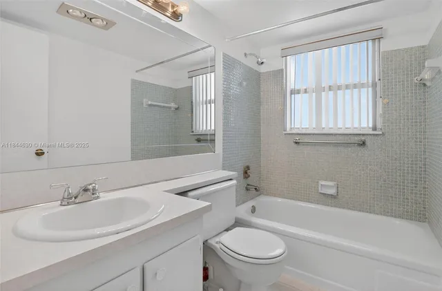 a bathroom with a sink a toilet and a bathtub