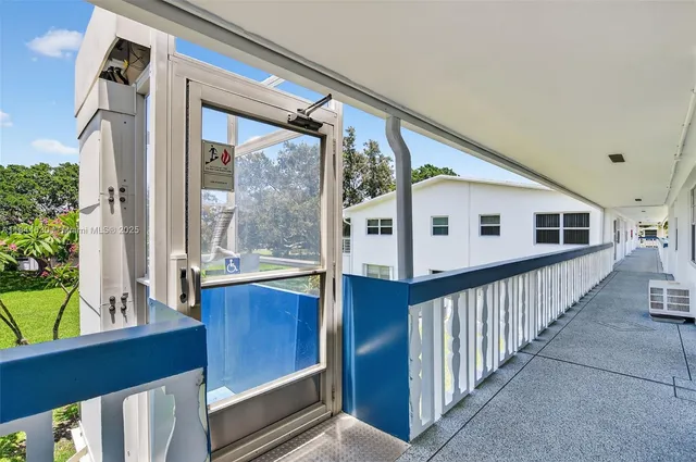 a view of a house with wooden floor and iron fence