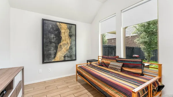 a bedroom with a bed and a window