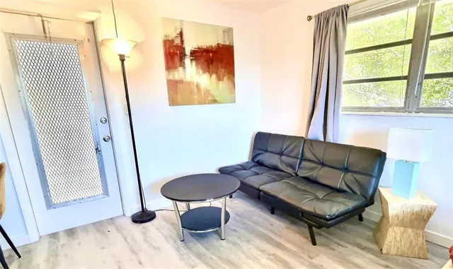 a living room with furniture and a window