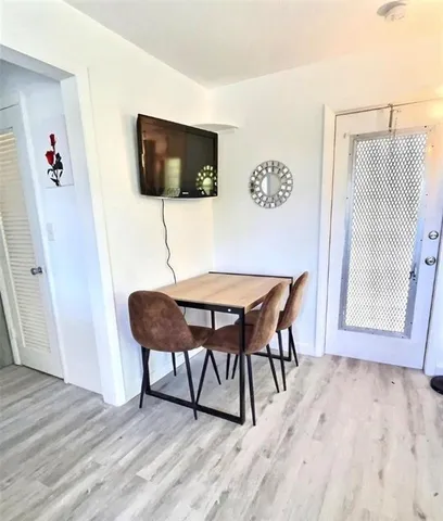 a dining room with furniture and wooden floor