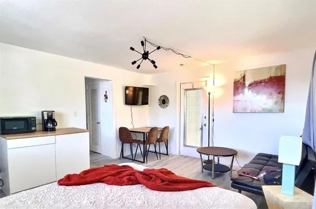 a bedroom with furniture and a chandelier