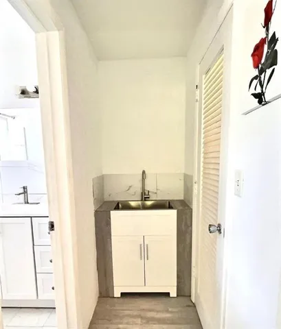 a bathroom with a sink a mirror and a vanity