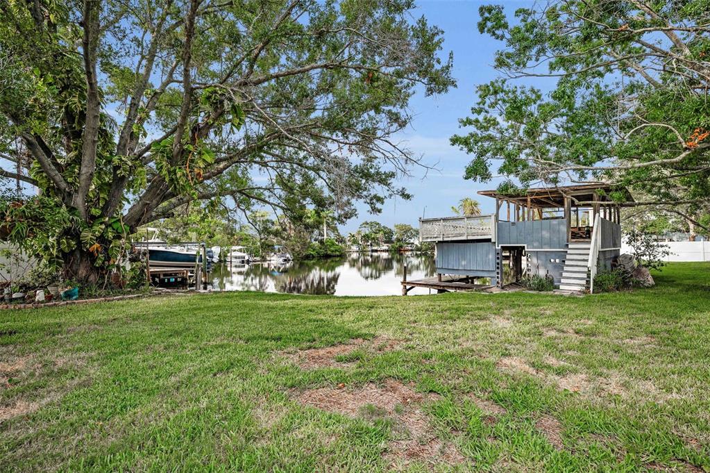 394 Georgia Avenue Crystal Beach, FL 34683 - Photo 23 of 69 a view of a house with a big yard and large trees