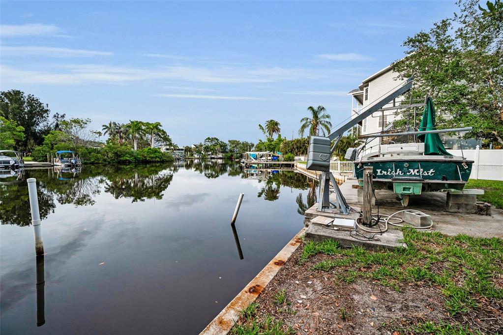 394 Georgia Avenue Crystal Beach, FL 34683 - Photo 27 of 69 a view of a lake with a yard and car parked