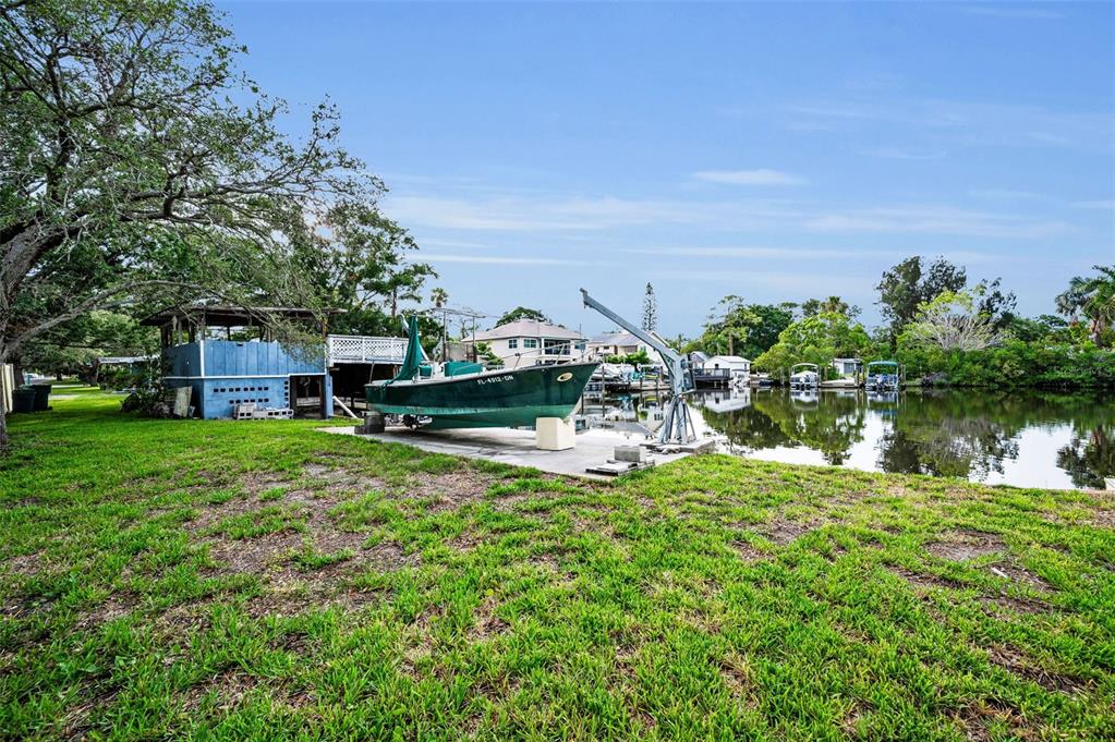 394 Georgia Avenue Crystal Beach, FL 34683 - Photo 28 of 69 a backyard of a house with lots of green space and lake view