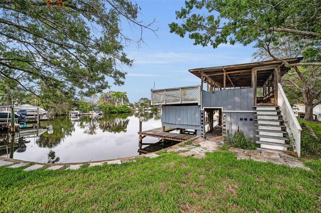 394 Georgia Avenue Crystal Beach, FL 34683 - Photo 3 of 69 a white house that has a tree in front of it