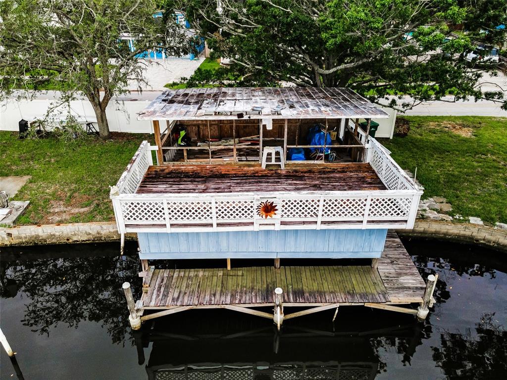 394 Georgia Avenue Crystal Beach, FL 34683 - Photo 5 of 69 a view of swimming pool with lawn chairs under an umbrella