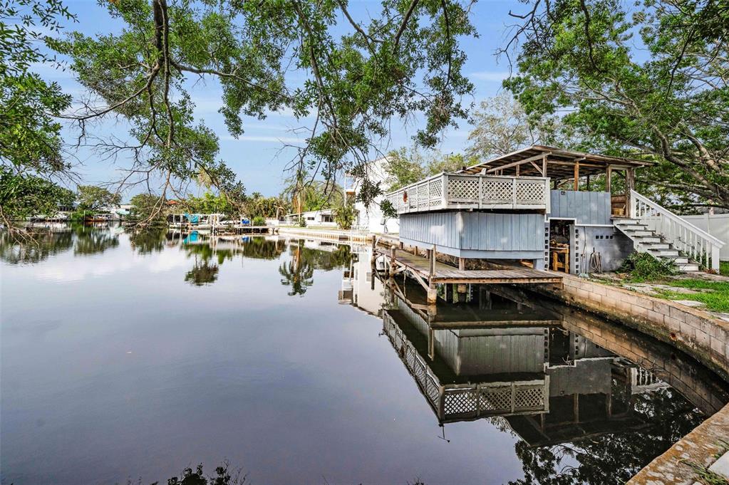 394 Georgia Avenue Crystal Beach, FL 34683 - Photo 6 of 69 a view of a lake with chairs