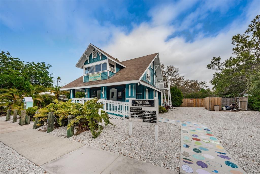 394 Georgia Avenue Crystal Beach, FL 34683 - Photo 65 of 69 a front view of a house with garden