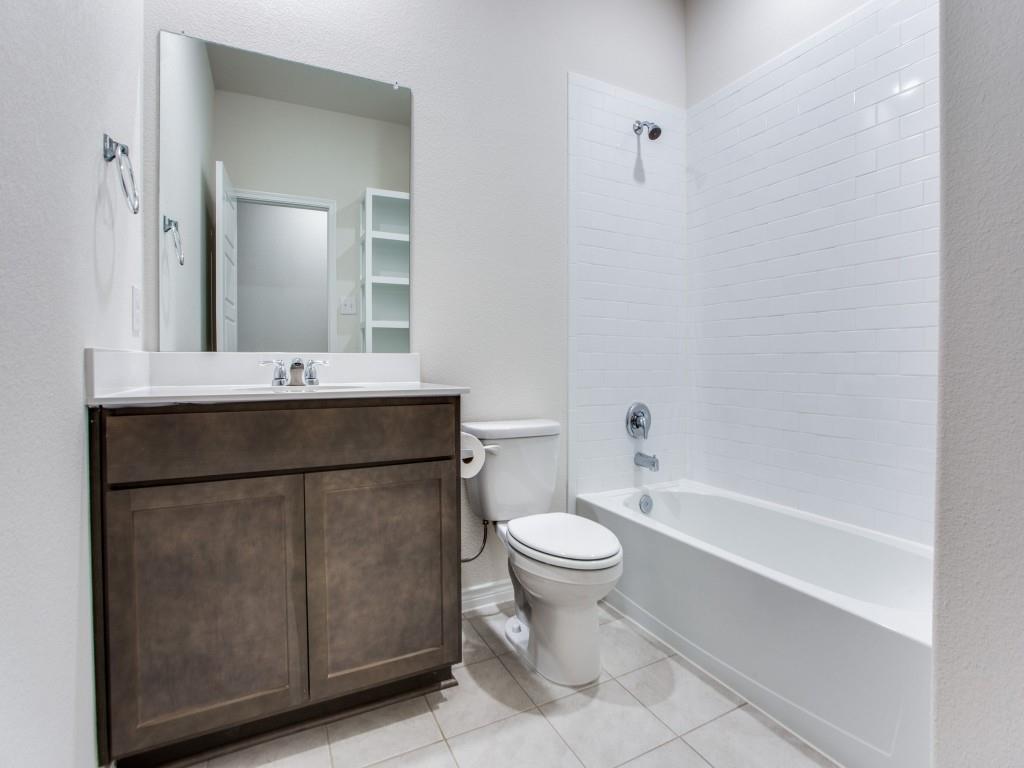 123 Lakeview Circle Pilot Point, TX 76258 - Photo 27 of 39 a bathroom with a sink toilet a mirror and shower