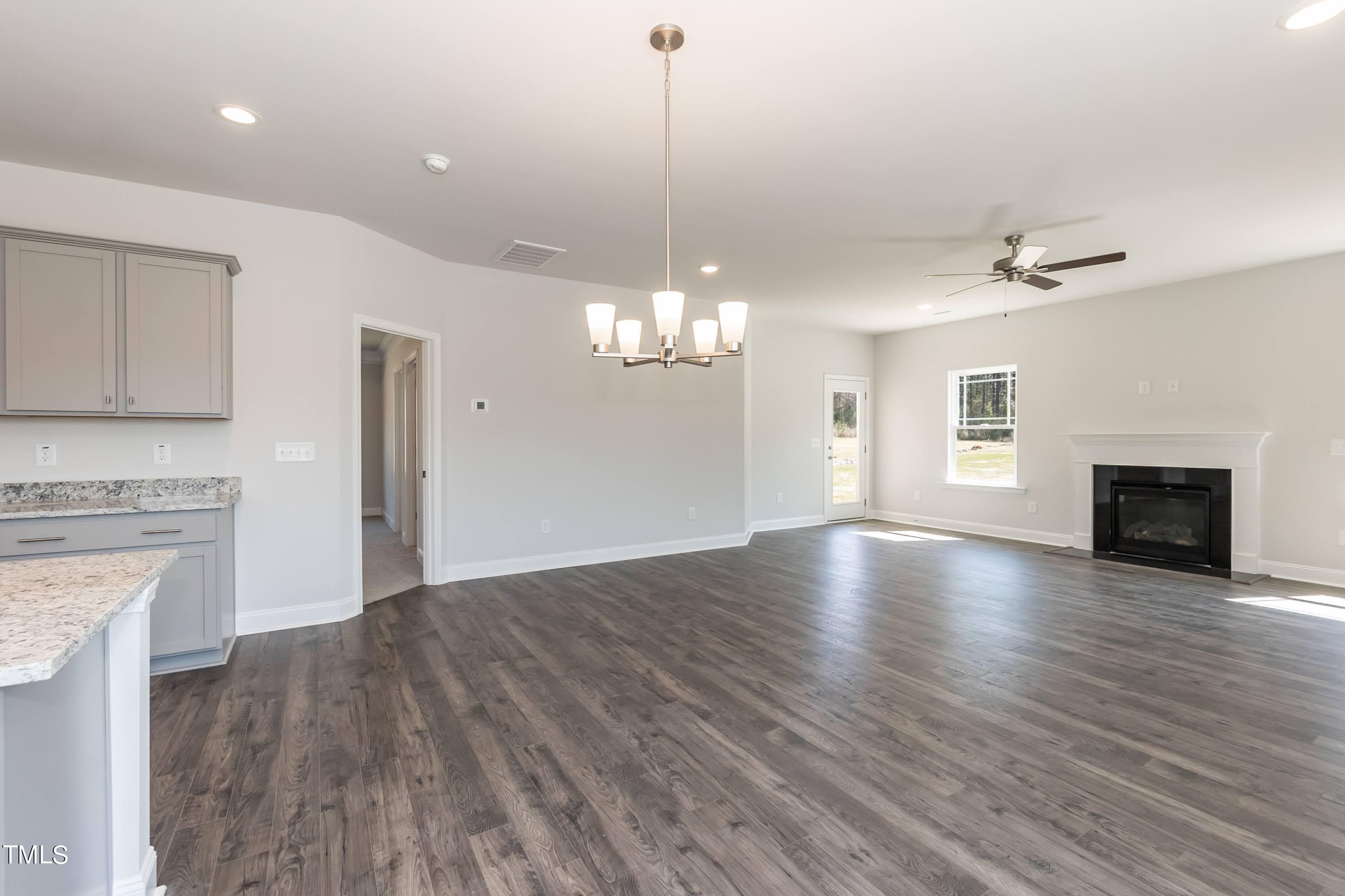 45 High Hampton Way Fuquay-Varina, NC 27526 - Photo 6 of 43 a view of a livingroom with a ceiling fan fireplace and wooden floor