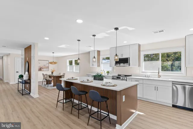 a large kitchen with a table and chairs