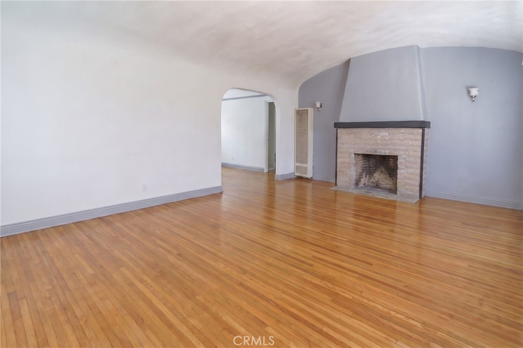 346 West School Street Compton, CA 90220 - Photo 9 of 29 a view of an empty room with wooden floor fireplace and a window