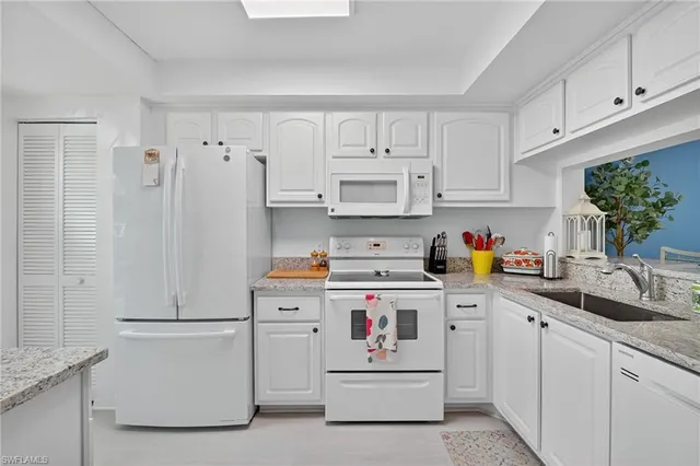 a kitchen with cabinets and white appliances