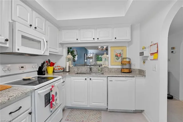 a kitchen with stainless steel appliances granite countertop a sink and cabinets