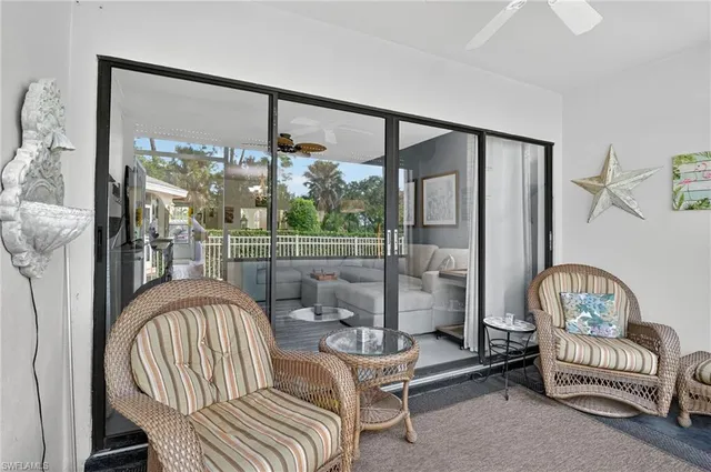 a living room with furniture and a floor to ceiling window