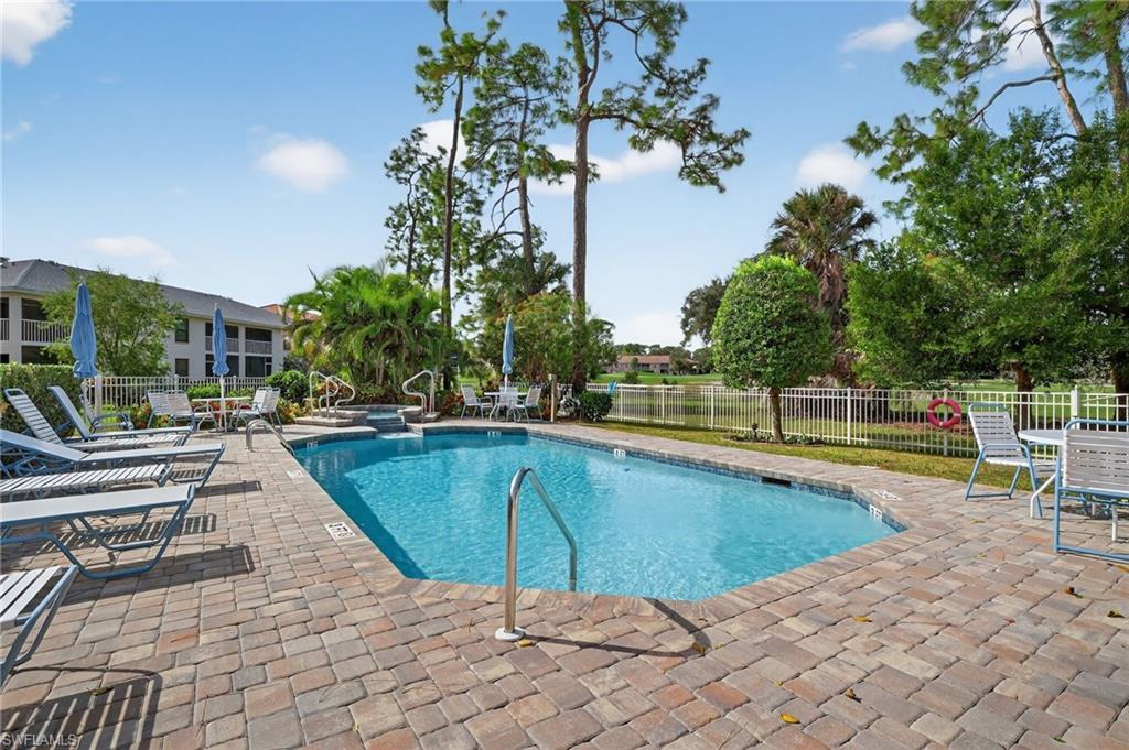 705 Augusta Boulevard, Unit 7054 Naples, FL 34113 - Photo 24 of 28 a view of a swimming pool with lounge chair
