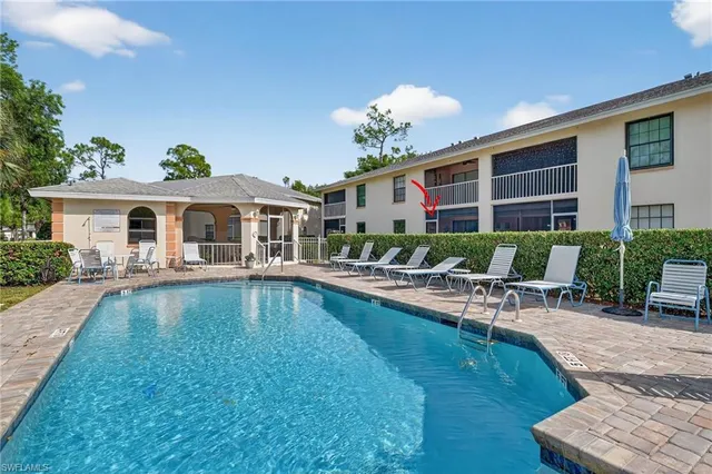 a view of a house with swimming pool and sitting area