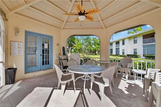 a dining room with furniture a chandelier and wooden floor