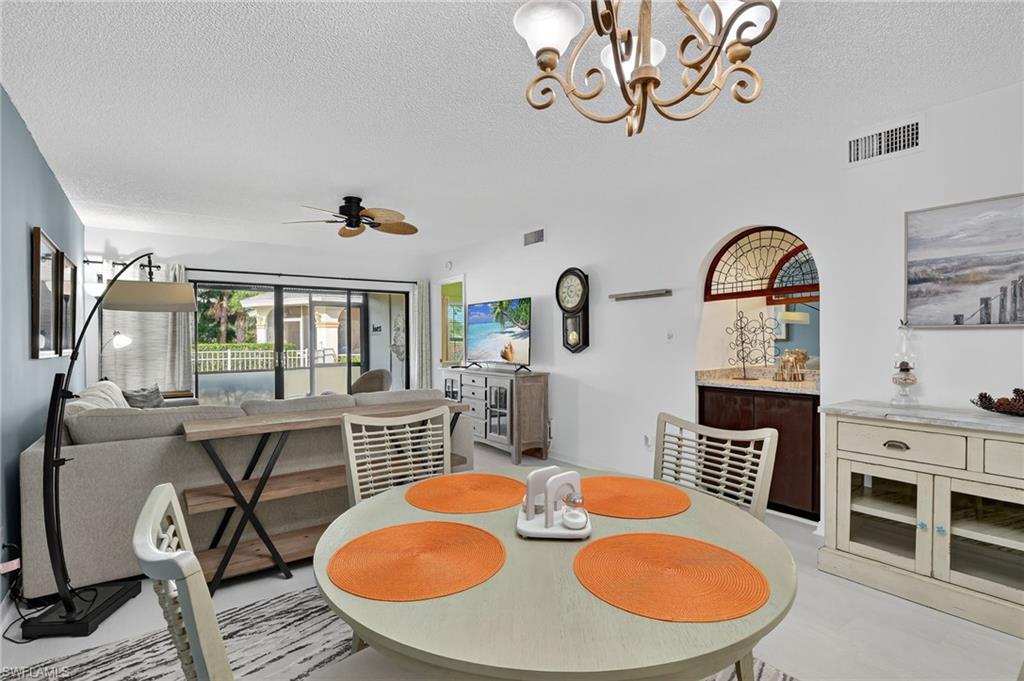 705 Augusta Boulevard, Unit 7054 Naples, FL 34113 - Photo 6 of 28 a view of a dining room with furniture window and wooden floor