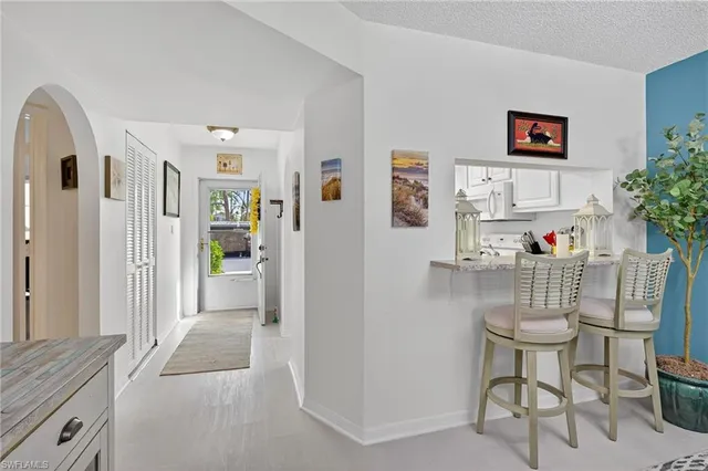 a living room with furniture and a painting on the wall