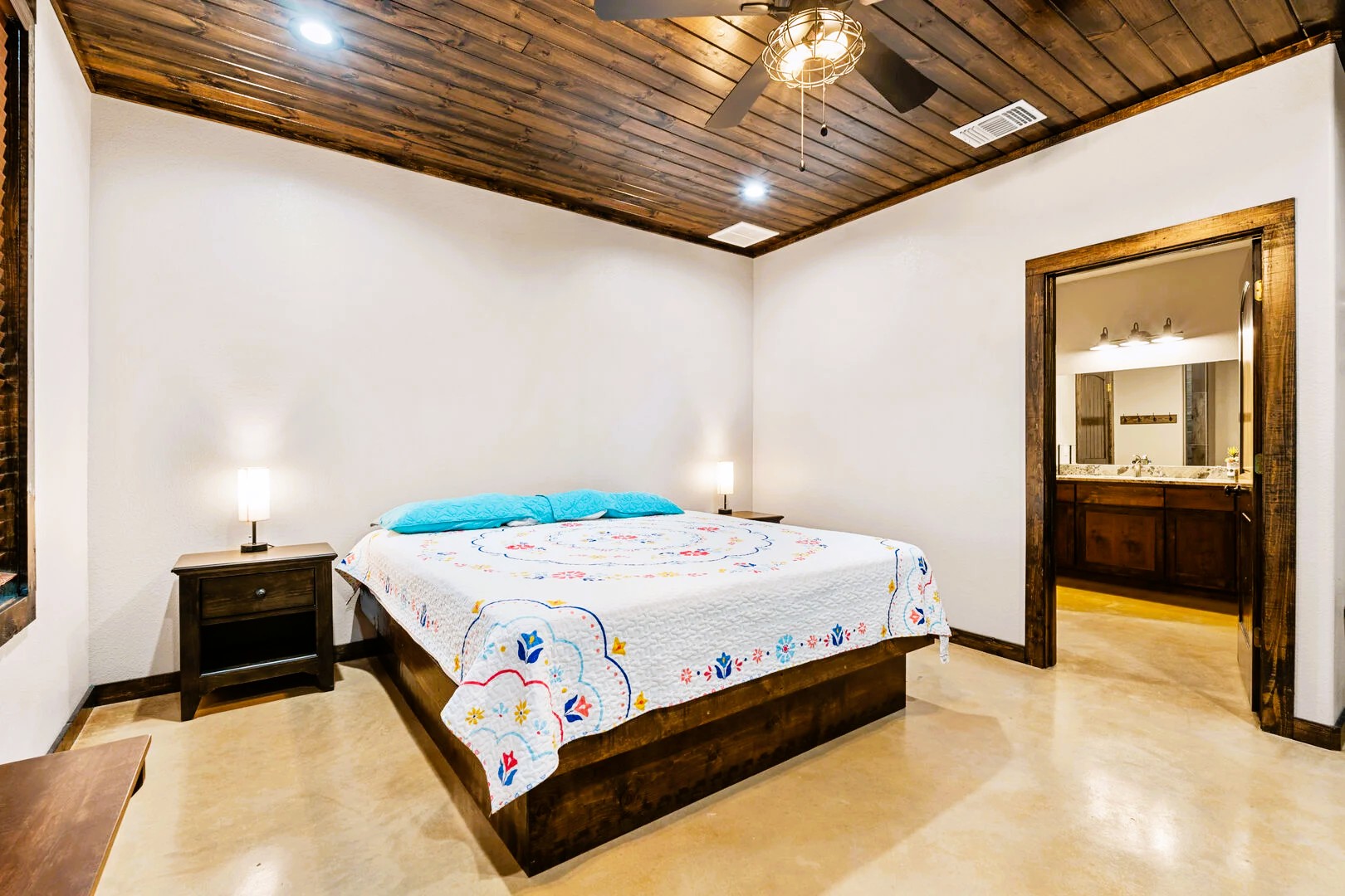 1718 Mountain Valley Road Concan, TX 78838 - Photo 21 of 40 Rich wood plank ceilings and polished concrete floors bring warmth to this comfortable bedroom.