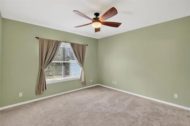 an aerial view of residential houses with outdoor space and lake view