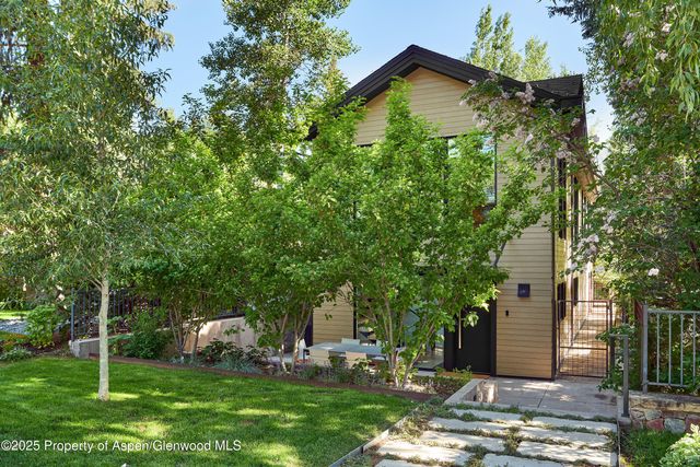a backyard of a house with barbeque oven and outdoor seating