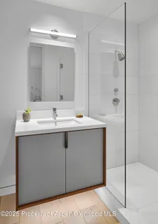 a bedroom with a bed a chair and next to a window