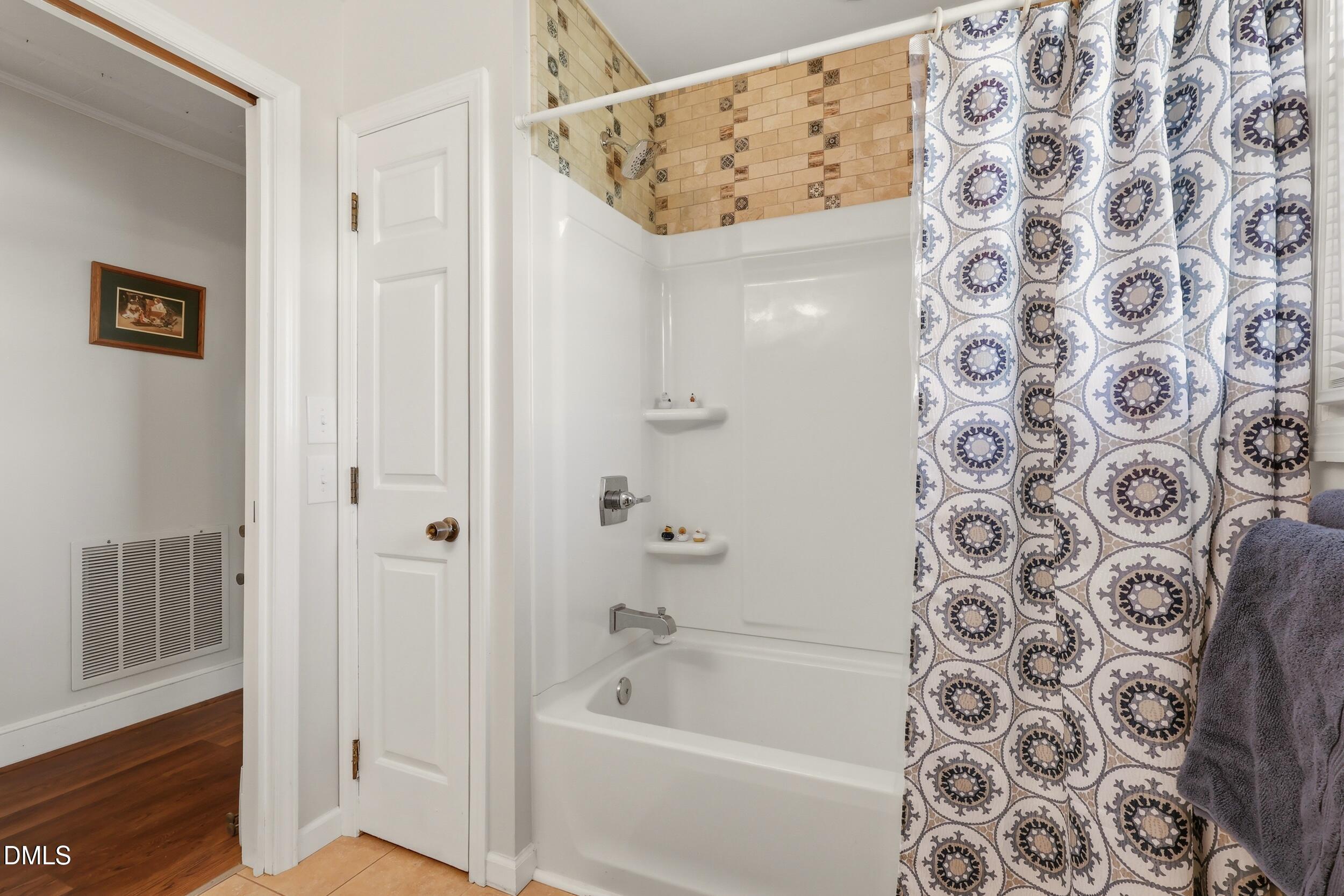 2631 South Jim Minor Road Haw River, NC 27258 - Photo 33 of 62 a bathroom with a bathtub and a shower