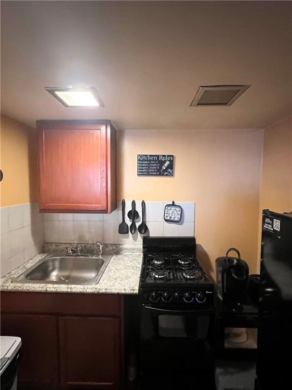 1619 Brownsville Road Pittsburgh, PA 15210 - Photo 11 of 33 a kitchen with a stove and a sink